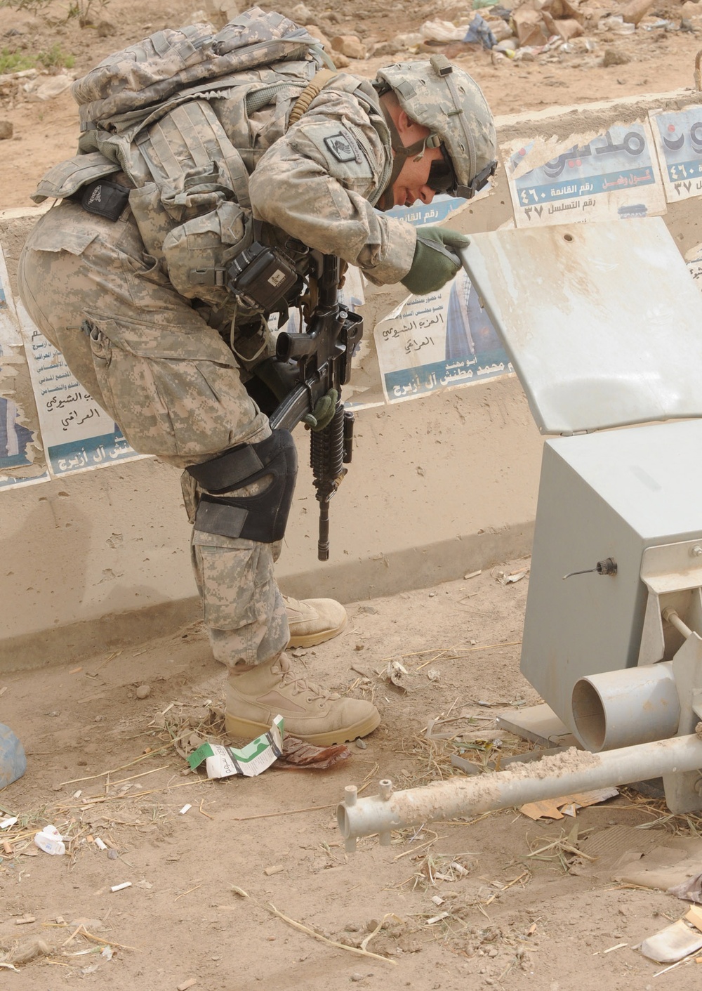 Army Sergeant Inspects Debris During Route Clearance Operation in Baghdad
