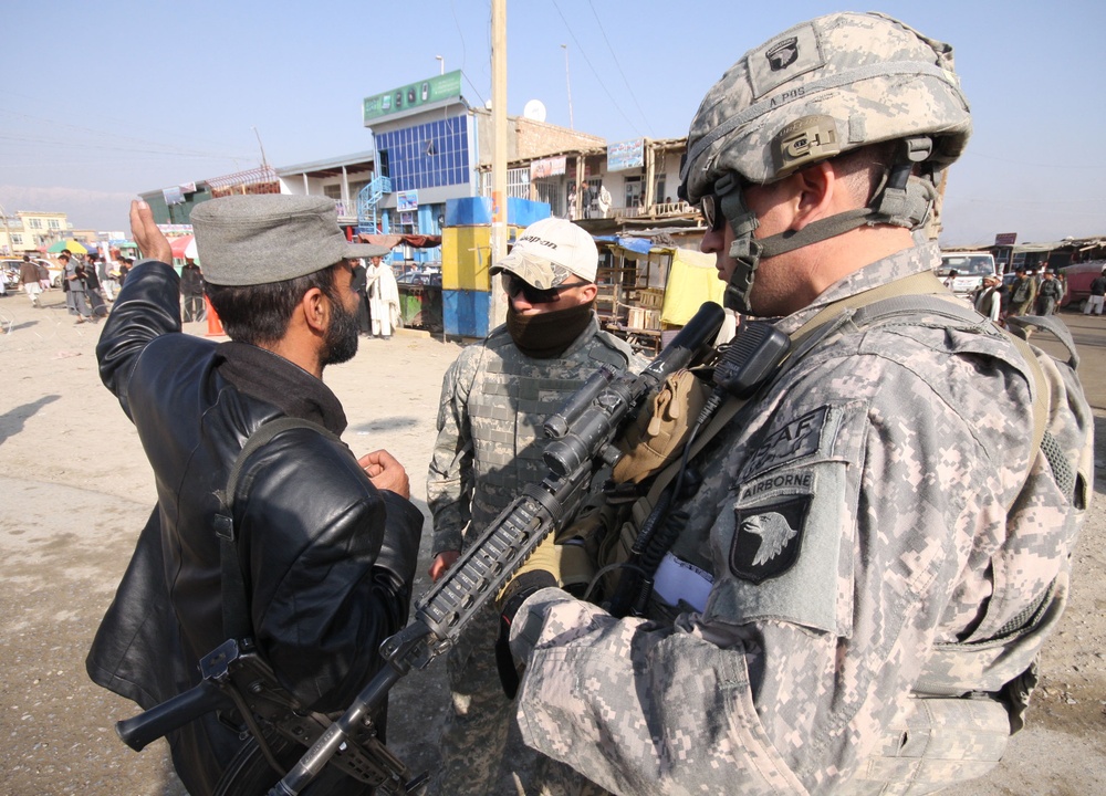 Afghan Police Captain Briefs U.S. Army Lieutenant at Checkpoint