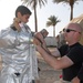 Airman Helps Iraqi Boy Suit Up in Firefighting Gear at Camp Victory