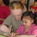 Young Iraqi Girl Helps Assemble Model Plane at Camp Victory