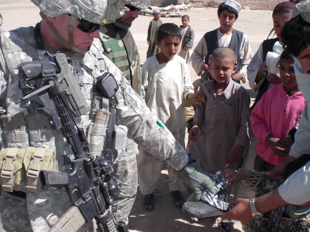 U.S. Soldier Distributes Shoes to Afghan Children