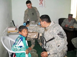 U.S. Soldiers Provide Medical Aid to Iraqi Boy During Humanitarian Mission
