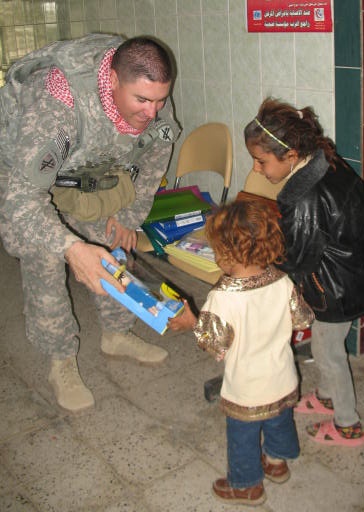 U.S. Soldier Distributes Toys to Iraqi Children During Humanitarian Mission