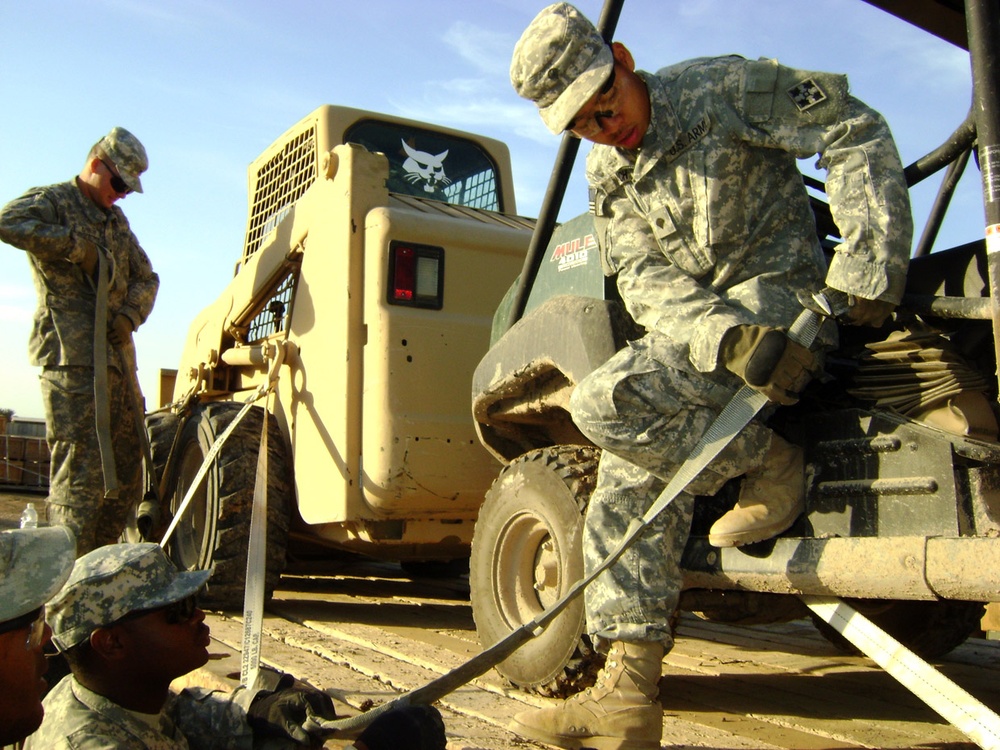 Army Soldiers Secure Equipment for Transport in Iraq