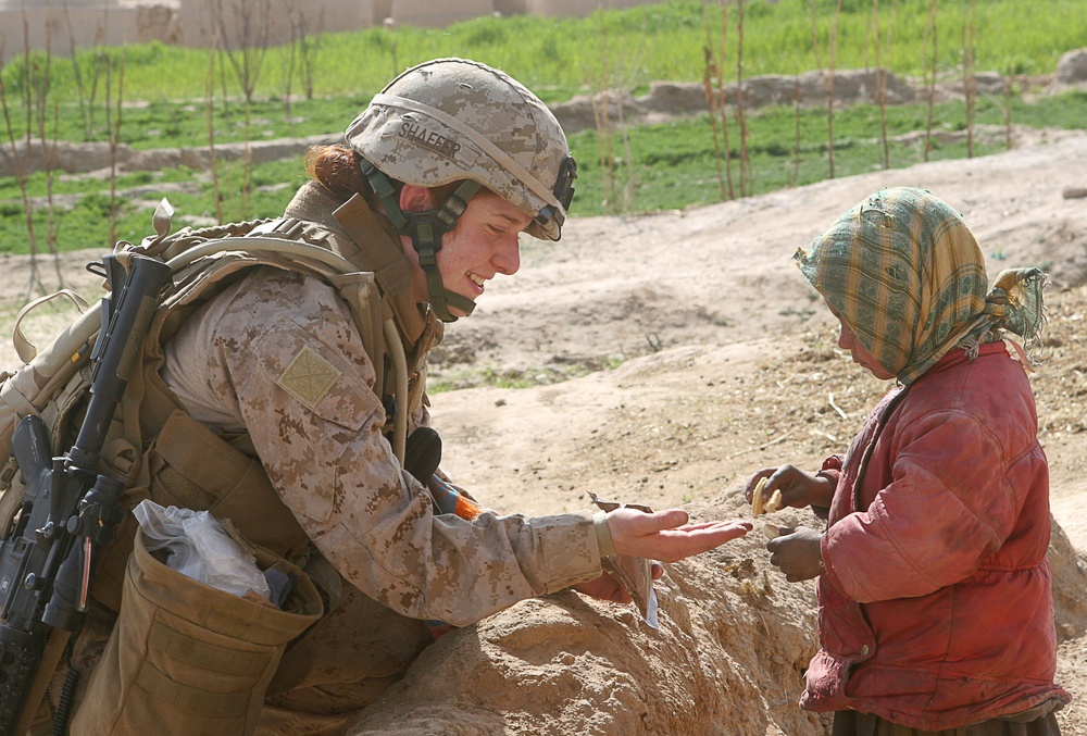 Marine Officer Shares Cookies and Smiles with Afghan Child