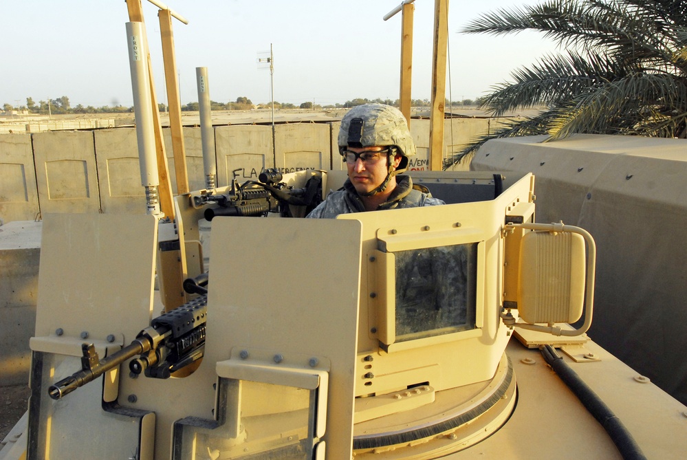 Soldier Prepares M-240B Machine Gun for Combat Patrol