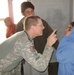 Air Force Medic Provides Care to Afghan Girl at School Clinic