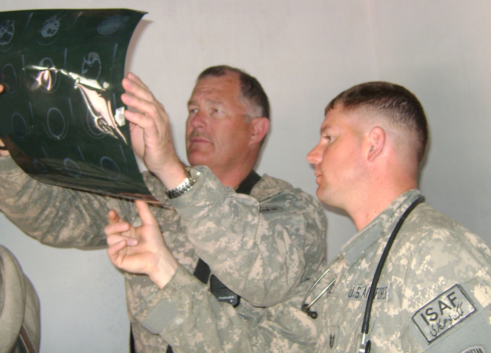 Air Force Medic and Army Civil Affairs Officer Examine X-Ray at Afghan Clinic