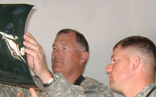 Air Force Medic and Army Civil Affairs Officer Examine X-Ray at Afghan Clinic