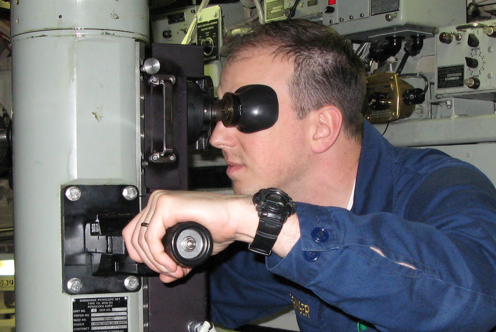 Navy Officer Peers Through Submarine Periscope