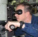 Navy Officer Peers Through Submarine Periscope