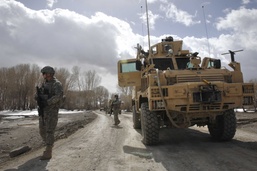 Security Forces Member Scans Area After Convoy Stops to Deliver Aid in Afghanistan