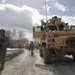 Security Forces Member Scans Area After Convoy Stops to Deliver Aid in Afghanistan