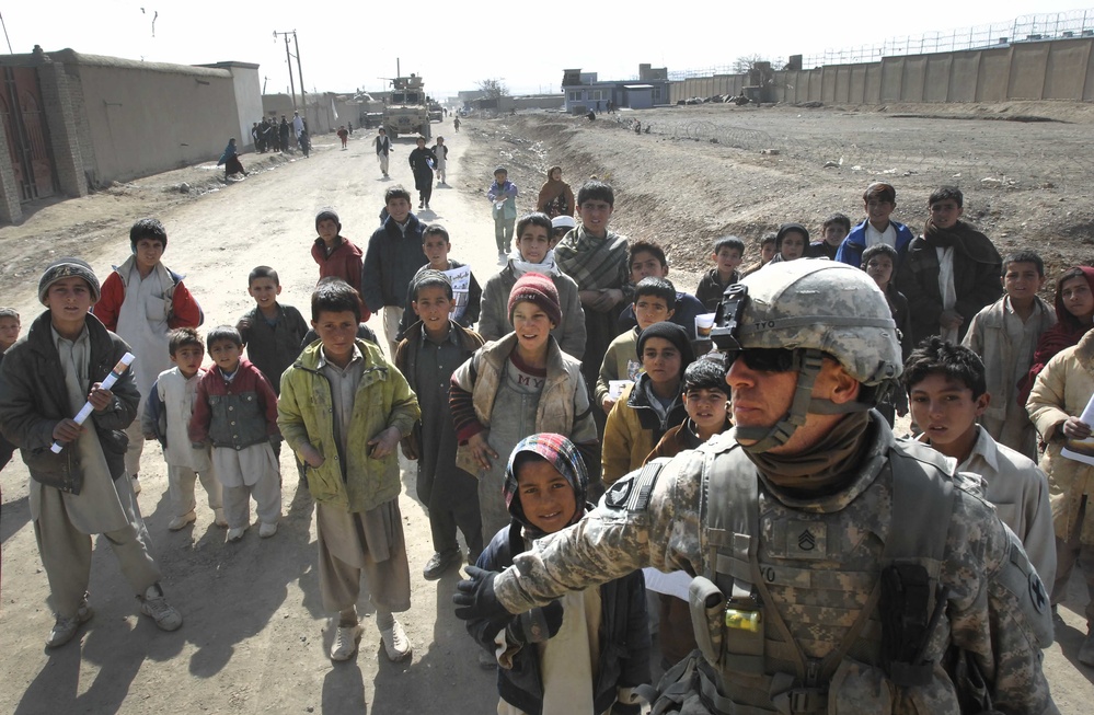 U.S. Soldier Holds Back Afghan Children Seeking Handouts