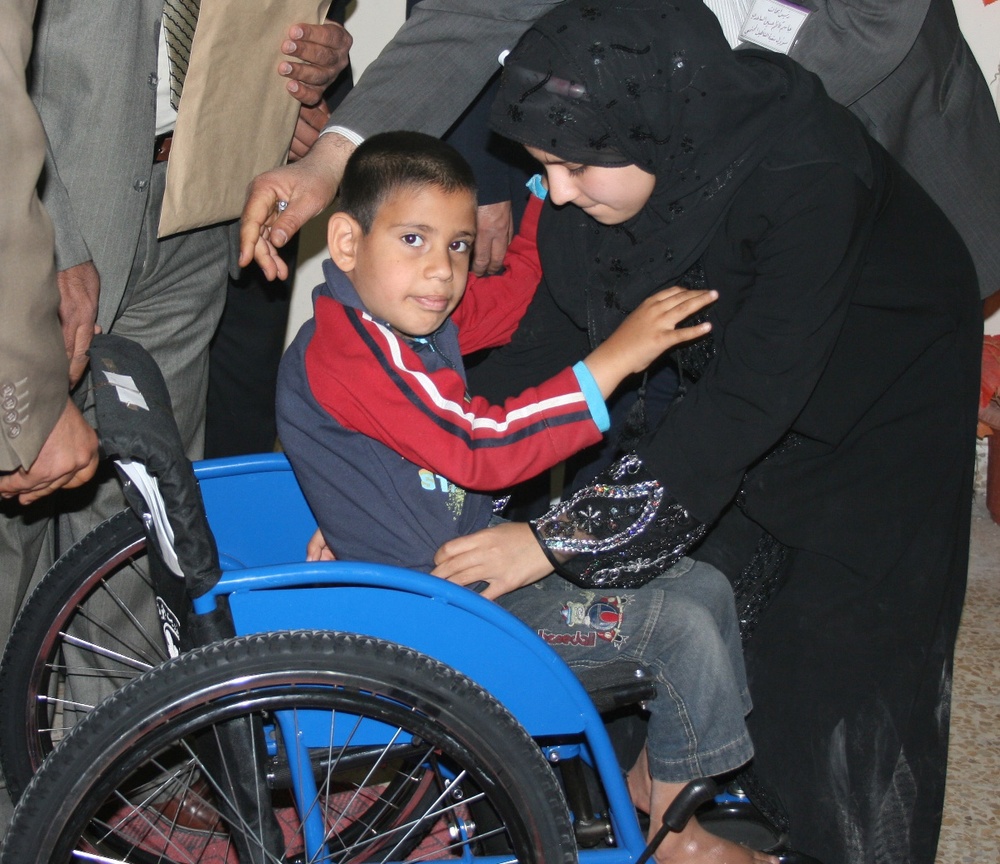 Child Receives New Wheelchair at Babil Rehabilitation Center in Iraq