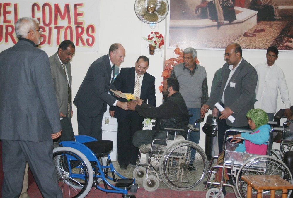 Babil Resident Receives Wheelchair Instruction from Provincial Reconstruction Team Leader