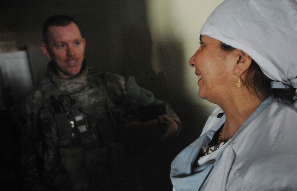 Female Afghan Doctor Discusses Medical Needs with U.S. Military Physician's Assistant