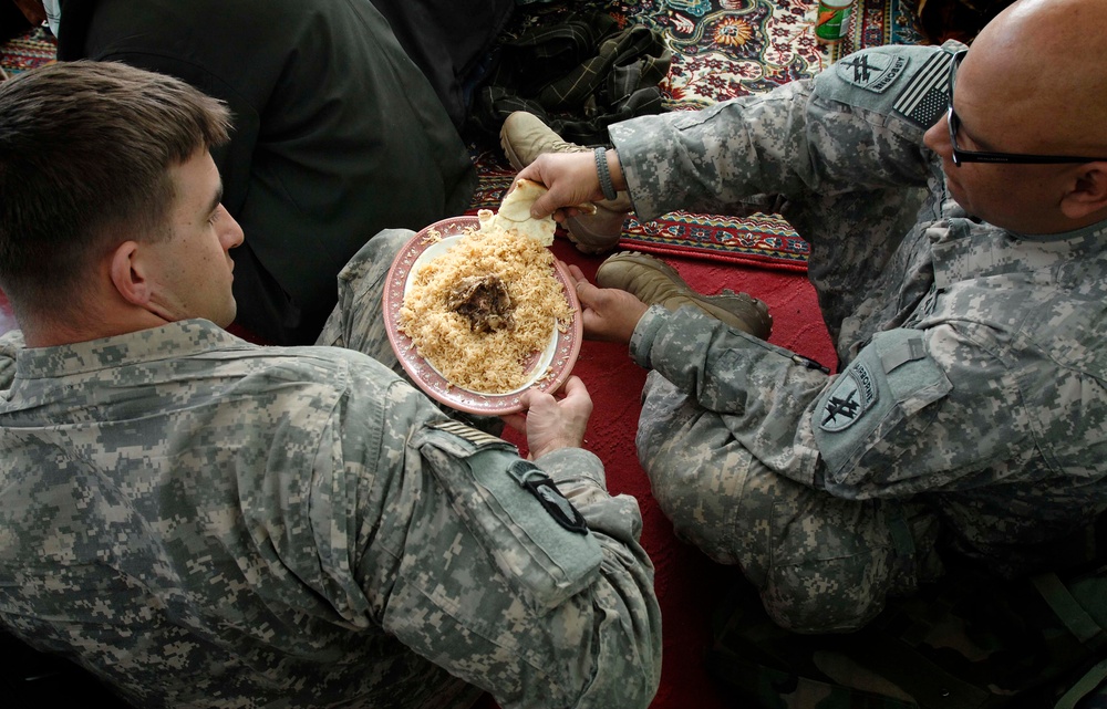 U.S. Army Captains Share Afghan Meal During Provincial Reconstruction Meeting