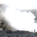 Iraqi Man Burns Garbage to Compact Landfill in Baghdad