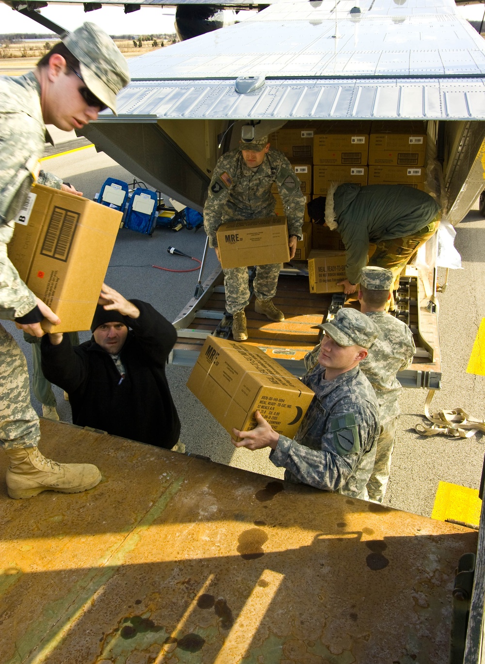 Soldiers Unload Supplies from C-23 Sherpa for Distribution