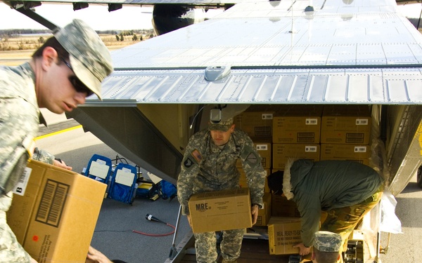 Soldiers Unload Supplies from C-23 Sherpa for Distribution