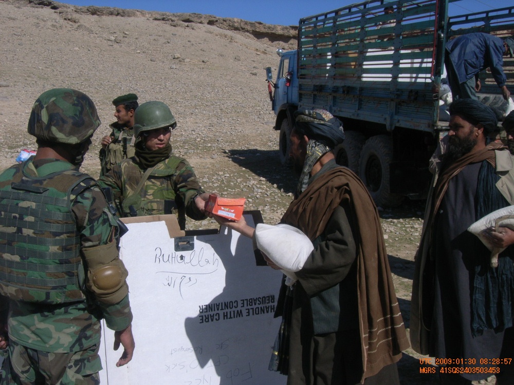 Afghan Soldier Provides Aid to Villager in Oruzgan Province