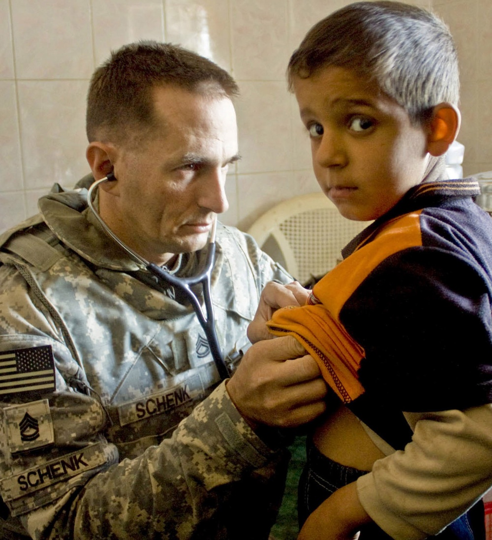 Army Medic Provides Care to Iraqi Boy During Medical Engagement