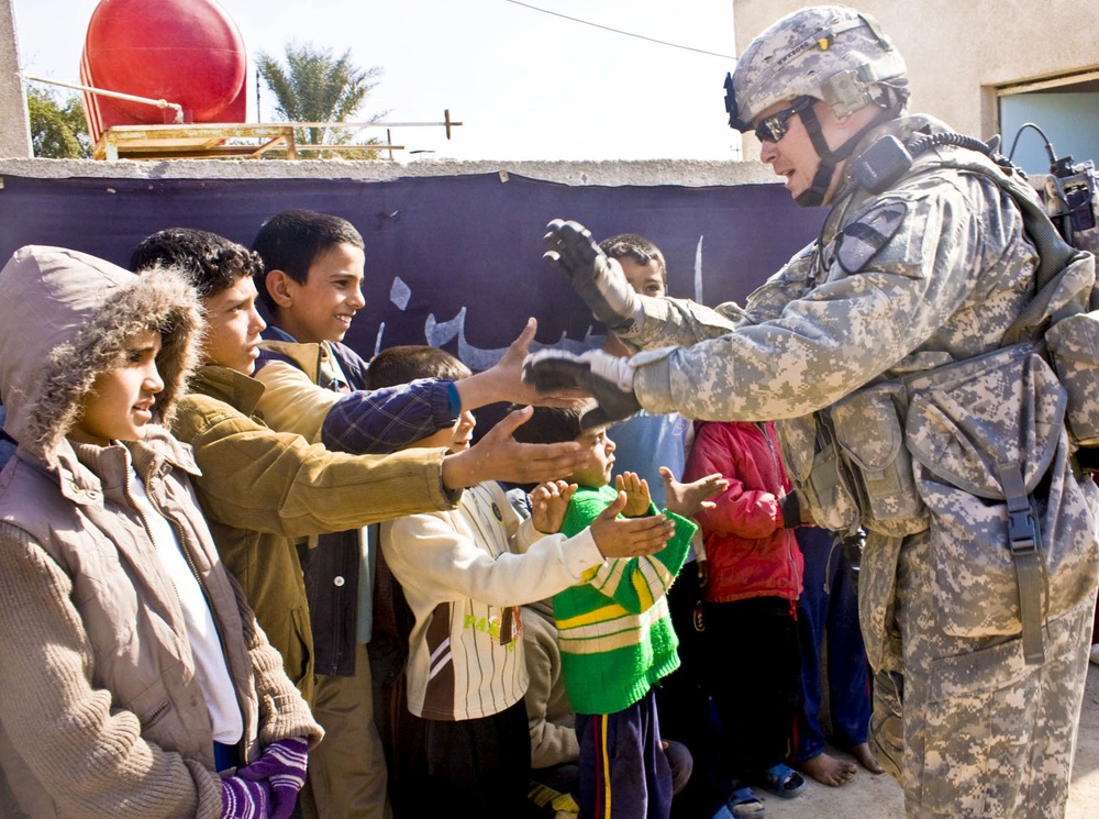 U.S. Soldier Greets Iraqi Children During Medical Engagement