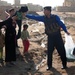 Iraqi Police Officer Distributes Aid to Families in Abu Rummanah