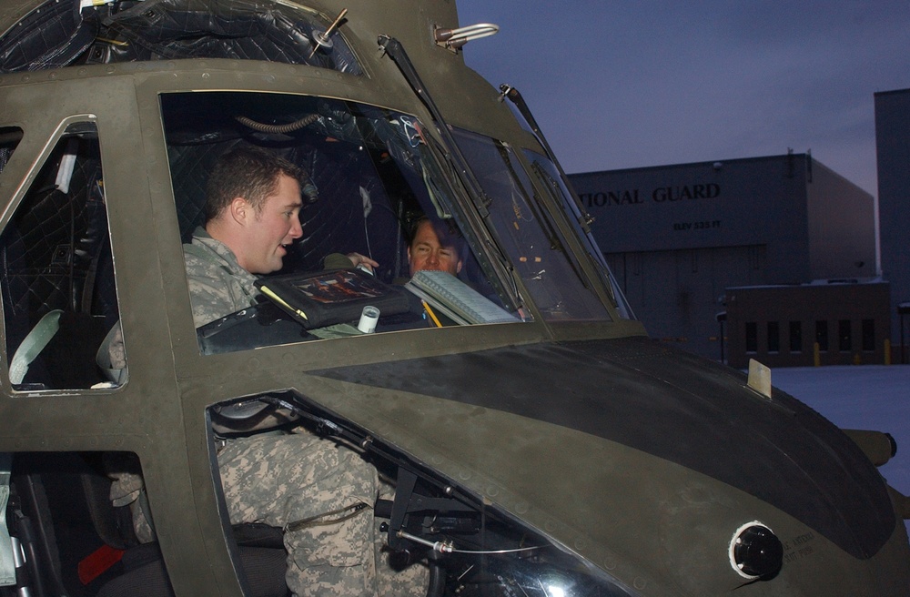 Army, Canadian Air Force Pilots Prepare for Night Flight in Chinook Helicopter