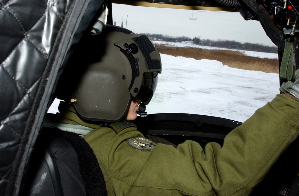 Canadian Air Force Pilot Performs Preflight Checks on NY National Guard Chinook