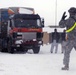Soldier Guides Truck Loaded with Equipment on Afghan Base