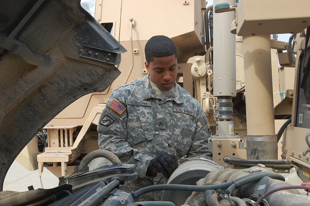 Army Mechanic Inspects Humvee Transmission in Iraq