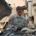 Army Mechanic Inspects Humvee Transmission in Iraq