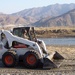 Army Sergeant Operates Bobcat to Improve Afghan Roads