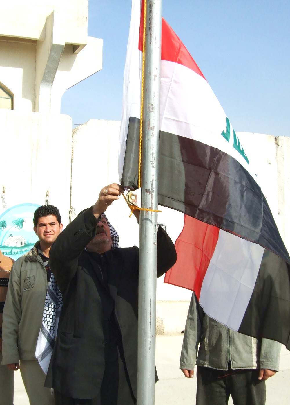 Iraqi Flag Raised Over Security Station, Marking Transition to Government Control