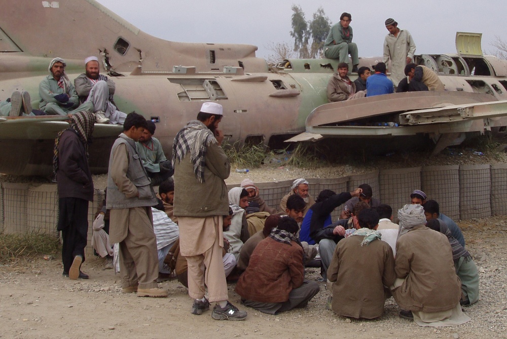 Afghan Workers Rest Near Relic of Past Conflict