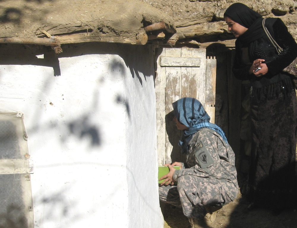 Afghan Woman Inspects Chicken Coop in Panjshir Province