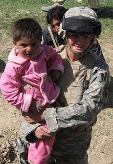 Wounded Soldier Comforts Afghan Girl During 2006 Tour