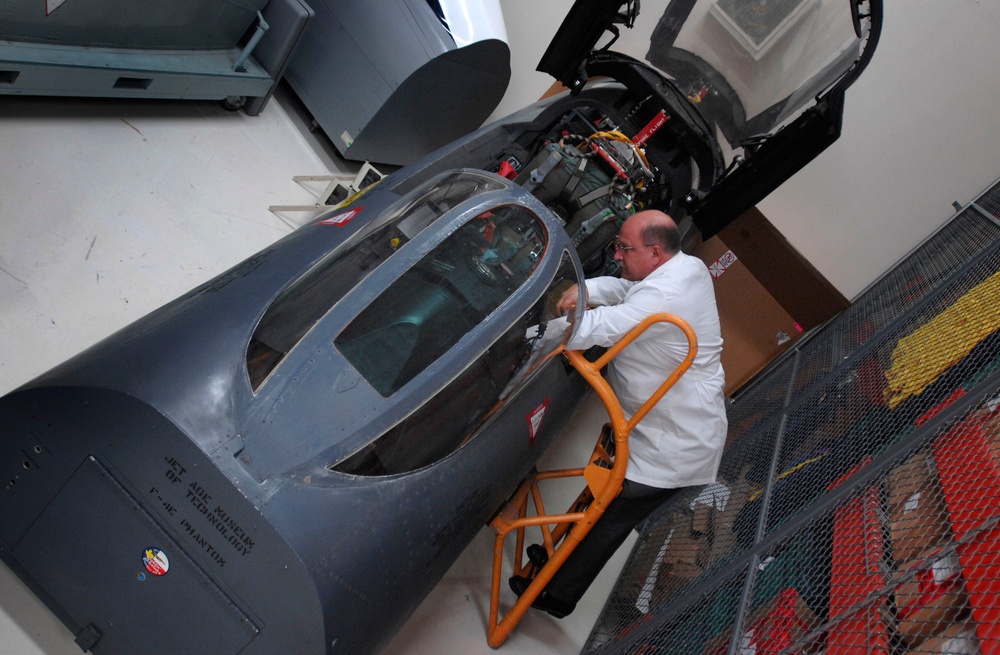 Equipment Analyst Examines Rebuilt Cockpit of F-4 Phantom II