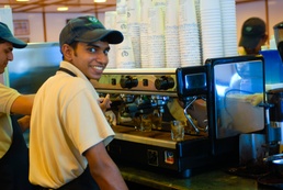 Barista Brews Espresso with a Smile at Green Beans Coffee in Iraq