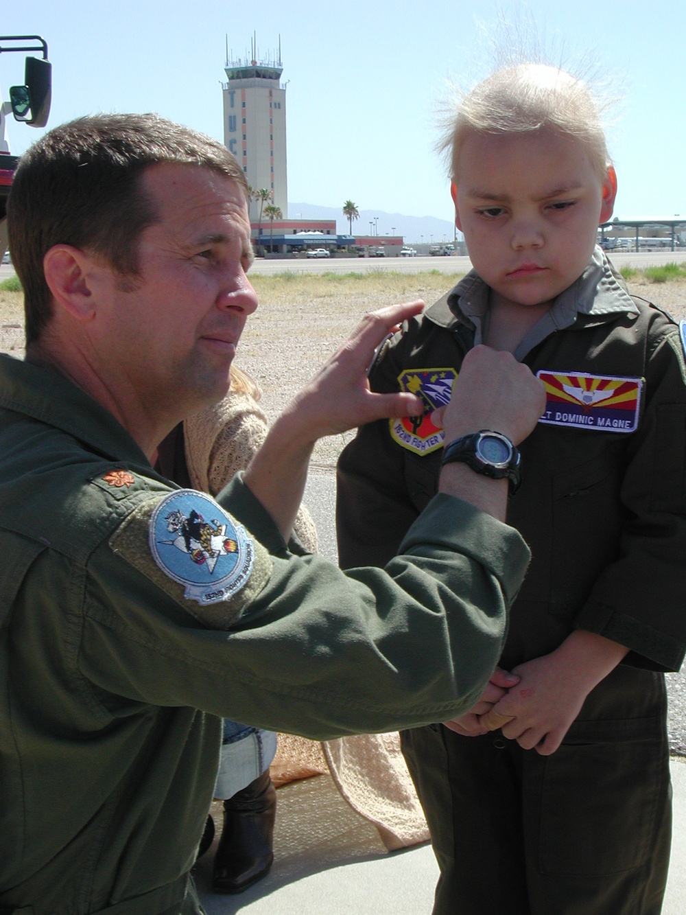 Air Force Officer Helps Young Boy Dress for Flight