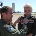 Air Force Officer Helps Young Boy Dress for Flight