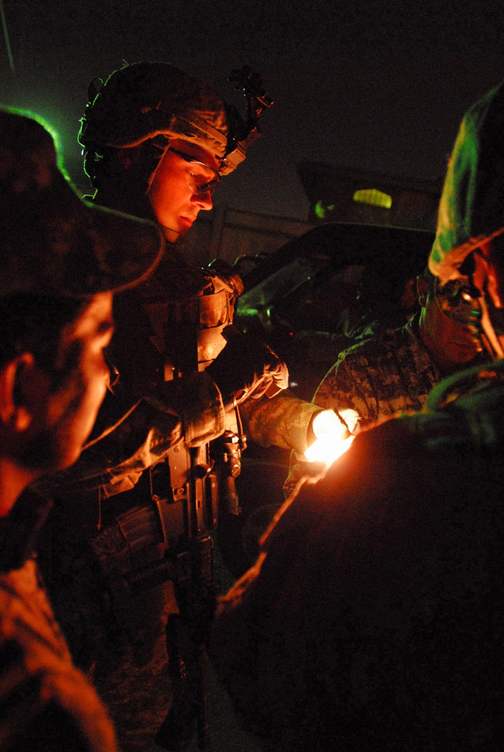 Army Staff Sgt. Checks Iraqi ID Card During Late-Night Patrol in Baghdad