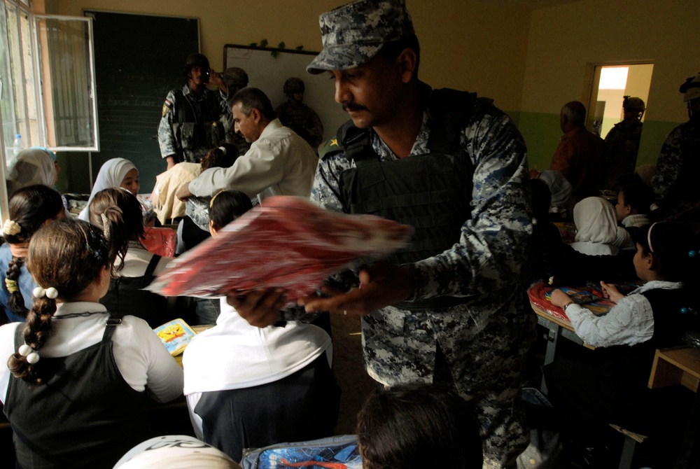 Iraqi Police Officer Distributes School Supplies to Children in Baghdad