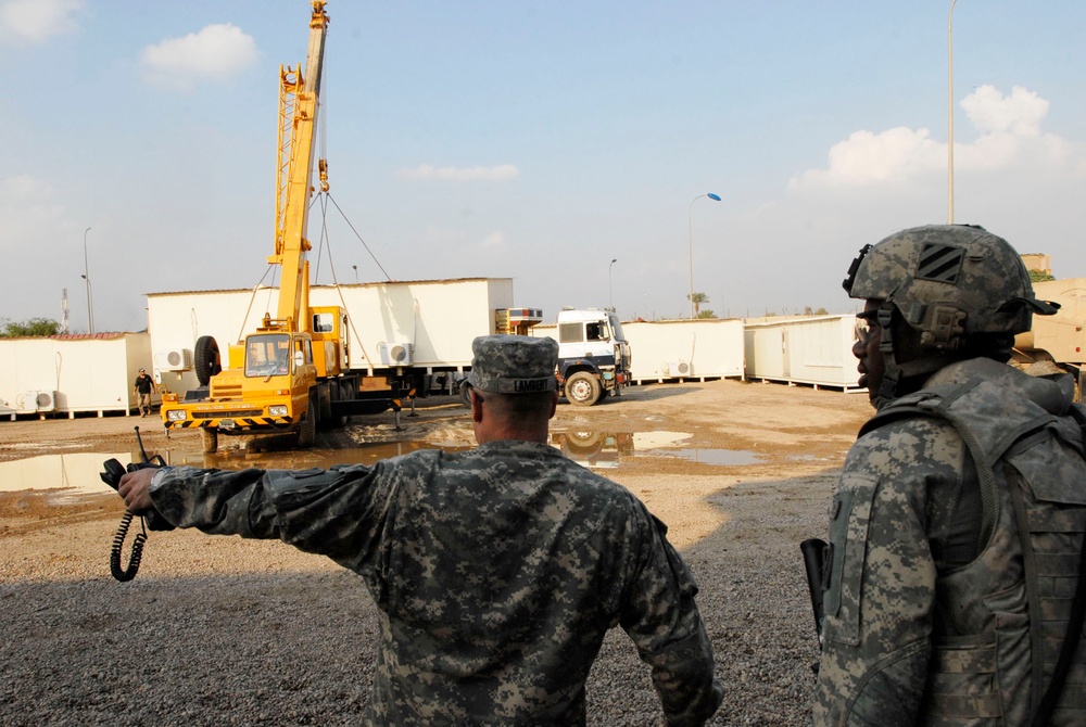U.S. Soldiers Oversee Iraqi Contractors Moving Armored Housing Units in Baghdad