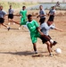 U.S. Soldier Competes for Soccer Ball with Iraqi Counterpart