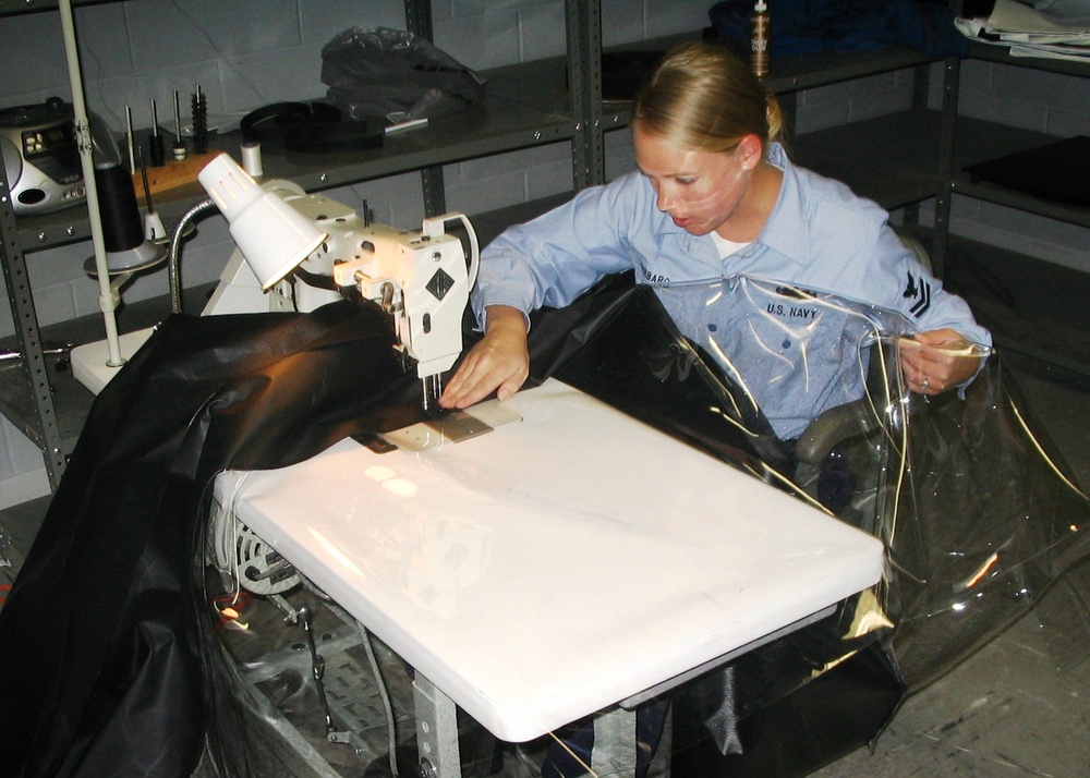 Navy Petty Officer Sews Foul-Weather Hatch Cover at Naval Facility
