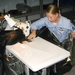 Navy Petty Officer Sews Foul-Weather Hatch Cover at Naval Facility