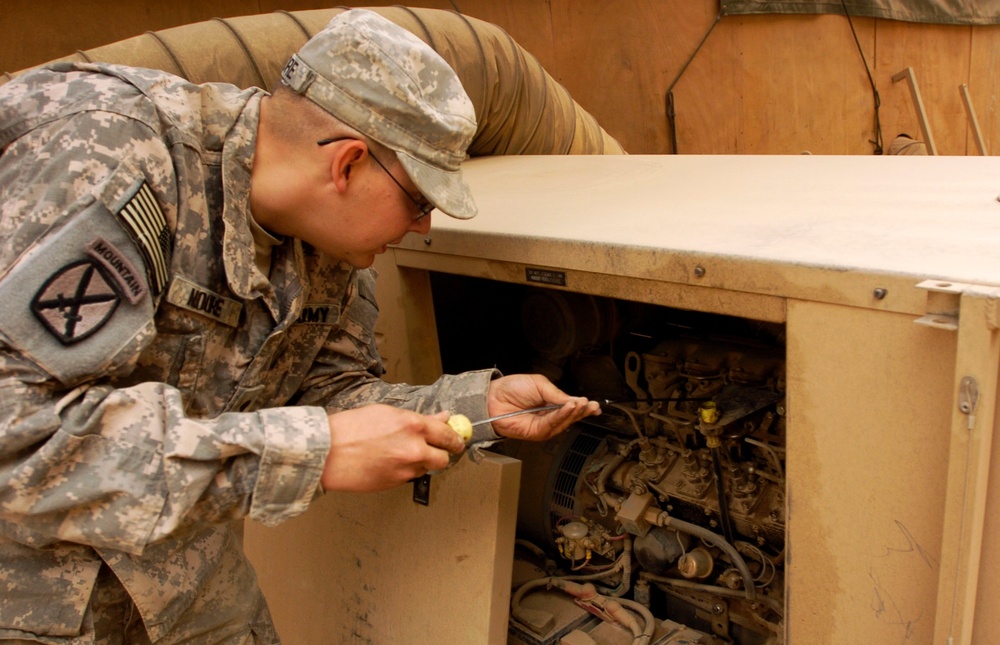 Soldier Performs Routine Maintenance on Power Supply in Iraq